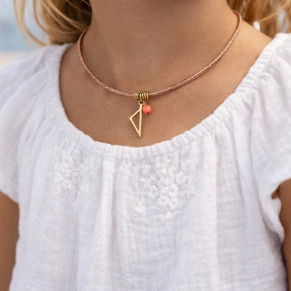 Collier enfant Isula en cordon rose avec pendentif Corse en acier inoxydable doré et tube de Corail rouge de Méditerranée